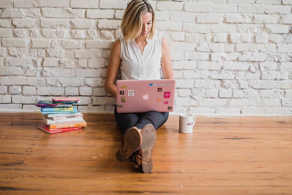 Person writing content on a laptop