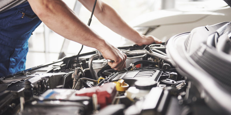 Person doing car maintenance