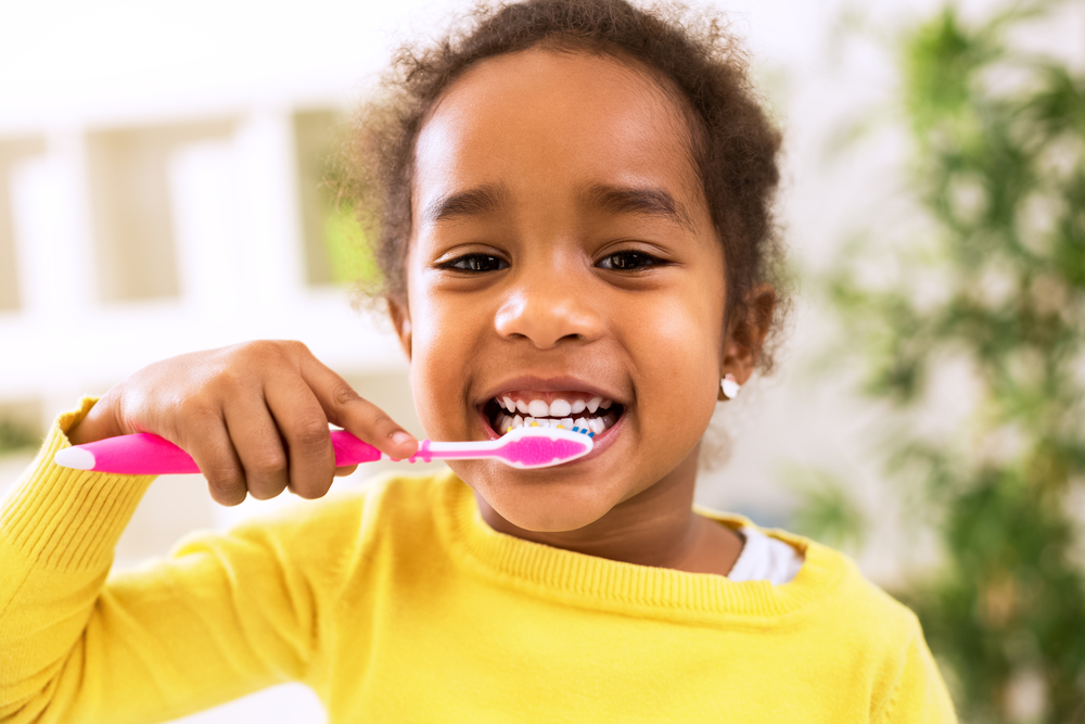 Child cleaning teeth for ACFF web design launch