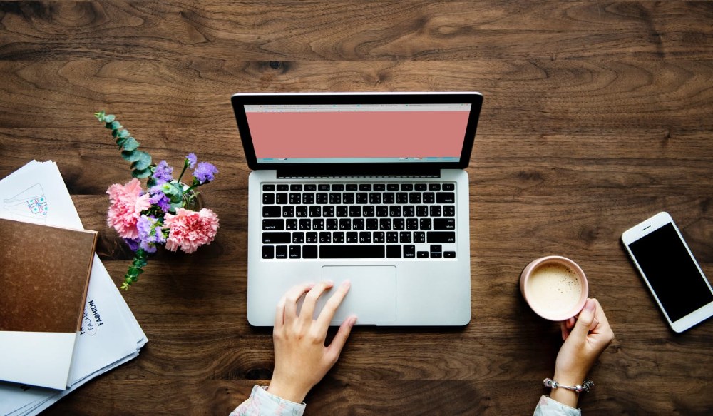 Person using a laptop with a blank screen