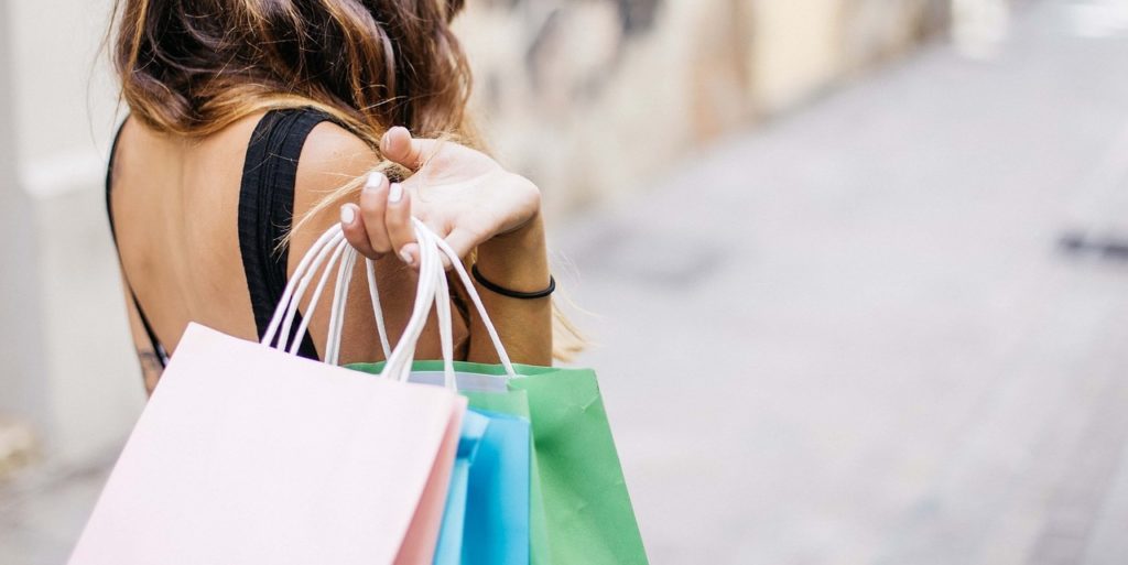 Woman with shopping bags after using e-commerce website