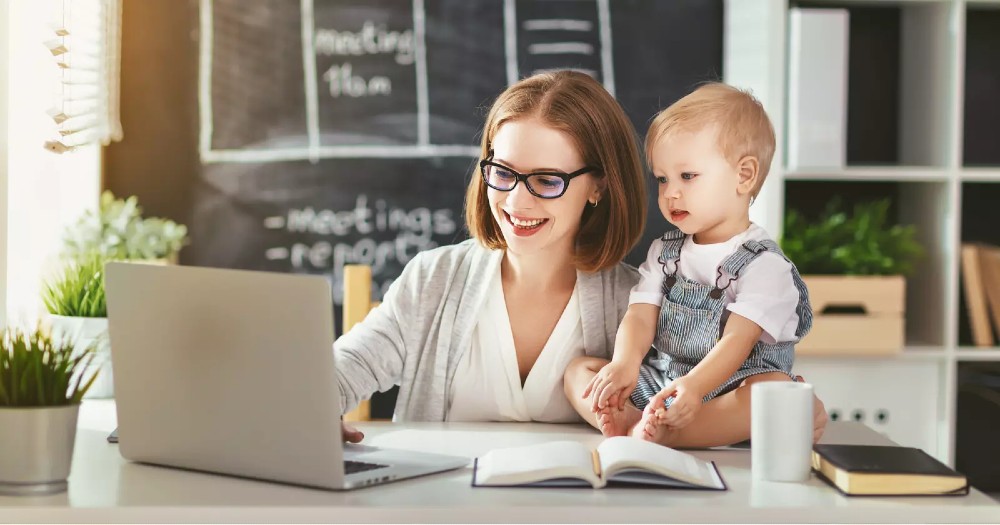 Woman working at home with a baby