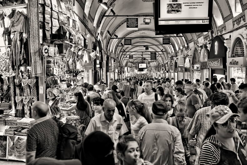 A crowd of people shopping at a large market